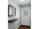 Bright entryway showcasing a floating shelf, decorative mirror, and a clear view of the front door at 1812 Overrun St, Charleston, SC 29414