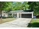 Charming single Gathering home with gray two car garage and a well manicured front lawn at 1812 Overrun St, Charleston, SC 29414