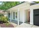 Inviting front porch with white columns and black shutters, leading to the front door at 1812 Overrun St, Charleston, SC 29414