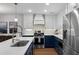 Updated kitchen with stainless steel appliances, white countertops and white and blue cabinetry at 1812 Overrun St, Charleston, SC 29414