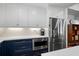 Kitchen featuring stainless steel refrigerator, white countertops and white and blue cabinetry at 1812 Overrun St, Charleston, SC 29414