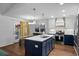 Beautiful kitchen featuring a large island, modern lighting, and stainless steel appliances at 1812 Overrun St, Charleston, SC 29414