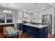Open concept kitchen with island seating, stainless steel appliances, and modern pendant lighting at 1812 Overrun St, Charleston, SC 29414