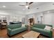Open living room with green sofas, hardwood floors, and view into the kitchen at 1812 Overrun St, Charleston, SC 29414