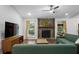Cozy living room showcasing a stone fireplace, ceiling fan, and natural light at 1812 Overrun St, Charleston, SC 29414