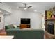 Cozy living room featuring a stone fireplace, ceiling fan, and comfortable green sofas at 1812 Overrun St, Charleston, SC 29414