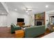 Inviting living room with stone fireplace, hardwood floors, and comfortable green sofas at 1812 Overrun St, Charleston, SC 29414