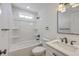 Clean bathroom with shower-tub combo, white vanity and fixtures, and a mounted mirror at 1932 Staffwood Rd, Johns Island, SC 29455