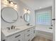 Modern bathroom features dual vanity, stylish fixtures, new flooring and tub at 1932 Staffwood Rd, Johns Island, SC 29455