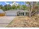 Charming single-story home with a well-manicured lawn, a two-car garage, and classic architectural details at 1932 Staffwood Rd, Johns Island, SC 29455