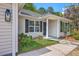 Charming home entrance featuring a classic column, a welcoming door, and meticulously maintained landscaping at 1932 Staffwood Rd, Johns Island, SC 29455