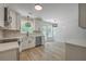 Bright kitchen with modern fixtures, stainless appliances, white cabinets and a breakfast nook overlooking backyard at 1932 Staffwood Rd, Johns Island, SC 29455