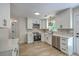 Bright kitchen features white cabinets, stainless steel appliances, stone countertops and modern light fixtures at 1932 Staffwood Rd, Johns Island, SC 29455