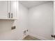Clean laundry room with white cabinets, utility connections, and laminate flooring at 1932 Staffwood Rd, Johns Island, SC 29455