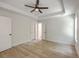 Spacious main bedroom features new floors, tray ceilings, ceiling fan, and bright windows at 1932 Staffwood Rd, Johns Island, SC 29455
