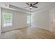 Spacious main bedroom features new floors, tray ceilings, ceiling fan, and bright windows at 1932 Staffwood Rd, Johns Island, SC 29455