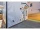 Backyard featuring an access door, a concrete pad and a side yard with artificial turf at 1956 Beech Ave, North Charleston, SC 29405