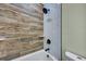 Bathroom featuring a shower, wood-look accent wall, and black shower fixture at 1956 Beech Ave, North Charleston, SC 29405
