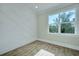 Bright, empty bedroom shows accent wall and large picture window at 1956 Beech Ave, North Charleston, SC 29405