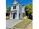 Charming two-story home featuring vertical siding, a gabled roof and a concrete driveway at 1956 Beech Ave, North Charleston, SC 29405