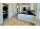 This well-appointed kitchen features stainless appliances, black countertops, and luxury vinyl flooring at 1956 Beech Ave, North Charleston, SC 29405