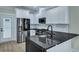 Kitchen features stainless steel appliances, subway tile backsplash, and dark countertops at 1956 Beech Ave, North Charleston, SC 29405