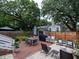 Inviting backyard features patio, dining area, lounge chairs, and mature trees at 2 Live Oak Ave, Charleston, SC 29407