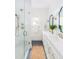 Bright bathroom with double vanity, white shaker cabinets, and glass shower enclosure at 2 Live Oak Ave, Charleston, SC 29407