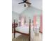 Charming bedroom featuring vaulted ceiling, a four-poster bed, and bright pink accents at 2 Live Oak Ave, Charleston, SC 29407