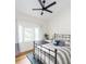 Bright bedroom with a decorative bedframe, desk, and windows for natural light at 2 Live Oak Ave, Charleston, SC 29407