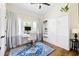 Bedroom with a desk area, built-in cabinets, and large windows for natural light at 2 Live Oak Ave, Charleston, SC 29407