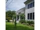 Beautiful two-story home with white siding, black windows, and lush green lawn at 2 Live Oak Ave, Charleston, SC 29407