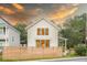 Beautiful two-story home featuring white siding, black windows, and a well-manicured lawn at 2 Live Oak Ave, Charleston, SC 29407