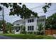 Charming two-story home featuring a covered porch and lush landscaping at 2 Live Oak Ave, Charleston, SC 29407
