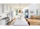 Spacious kitchen with a long island, white cabinets, and ample natural light from nearby windows at 2 Live Oak Ave, Charleston, SC 29407