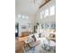 Bright living room featuring vaulted ceilings, oversized windows, and stylish decor at 2 Live Oak Ave, Charleston, SC 29407