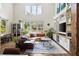 Airy living room with high ceilings, large windows, and a comfortable leather sectional sofa at 2 Live Oak Ave, Charleston, SC 29407