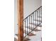 Modern staircase with black railings and exposed wood beams at 2 Live Oak Ave, Charleston, SC 29407