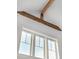 Bright room featuring a large window with white trim and a wood beam at 2 Live Oak Ave, Charleston, SC 29407