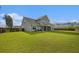 Large backyard with green lawn, privacy fence, and screened porch for outdoor relaxation and entertainment at 200 Clearblue Loop, Summerville, SC 29486