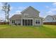 Spacious backyard featuring a screened porch and a patio area with chairs for outdoor relaxation at 200 Clearblue Loop, Summerville, SC 29486