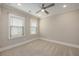 A light and airy bedroom boasts neutral walls and carpet, complemented by bright white trim and window blinds at 200 Clearblue Loop, Summerville, SC 29486