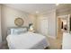 Cozy bedroom showcases a comfortable bed, decorative mirror and artwork, all enhanced by neutral tones at 200 Clearblue Loop, Summerville, SC 29486