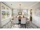 Well-lit dining room features a wood table, pendant lighting, and views of the outdoors at 200 Clearblue Loop, Summerville, SC 29486
