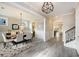 Elegant dining room with wood table, modern chandelier, gray chairs, and decorative rug at 200 Clearblue Loop, Summerville, SC 29486