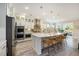 Spacious kitchen with white cabinets, stainless steel appliances, a large island, and modern pendant lights at 200 Clearblue Loop, Summerville, SC 29486