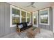 Relaxing screened porch with comfortable seating and overhead fan, perfect for enjoying the outdoors at 200 Clearblue Loop, Summerville, SC 29486