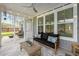 Cozy screened porch with comfortable sofa, coffee table, and views of the serene backyard at 200 Clearblue Loop, Summerville, SC 29486