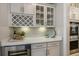 Stylish wet bar with wine cooler, white countertop, glass front cabinets and beverage storage at 200 Clearblue Loop, Summerville, SC 29486