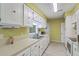 Galley kitchen featuring white cabinets and stainless steel sink at 201 Hunt Club Dr, Summerville, SC 29485